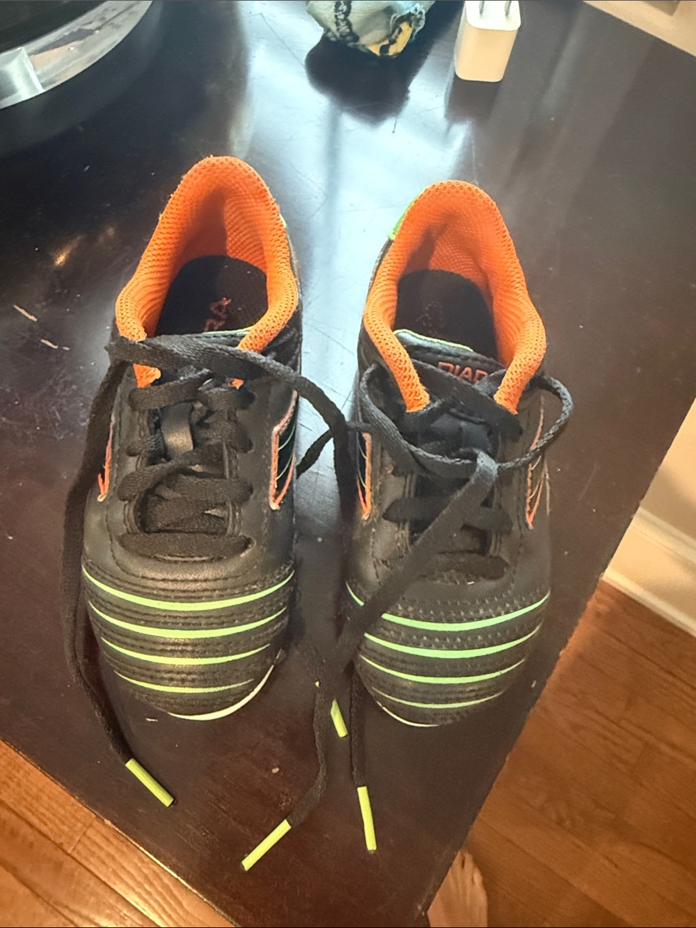 Diadora Black Soccer cleats with Orange Lining and Lime Green Stripes